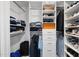 Organized walk-in closet featuring built-in shelving, drawers, and hanging rods for optimal storage at 122 N Harrington St # 775, Raleigh, NC 27603