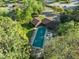 Aerial view of covered community pool surrounded by lush greenery on a sunny day at 1220 Manassas Ct Ct # E, Raleigh, NC 27609