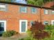 Charming townhouse entrance with brick facade and manicured front garden at 1220 Manassas Ct Ct # E, Raleigh, NC 27609