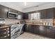 Efficient kitchen layout with stainless appliances and complementary backsplash at 1220 Manassas Ct Ct # E, Raleigh, NC 27609