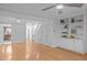 Open-concept living space with hardwood floors and custom built-in shelving at 1220 Manassas Ct Ct # E, Raleigh, NC 27609