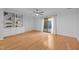 Bright living room features hardwood floors, built-in shelves, and sliding glass doors at 1220 Manassas Ct Ct # E, Raleigh, NC 27609