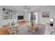 Inviting living area with sliding glass doors, wood flooring and built-in shelves at 1220 Manassas Ct Ct # E, Raleigh, NC 27609