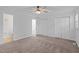 Spacious main bedroom with carpet flooring, ceiling fan, and closet perfect for relaxing at 1220 Manassas Ct Ct # E, Raleigh, NC 27609