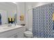 Bathroom featuring vanity with silver faucet, toilet, and shower with patterned curtain at 1243 White Flint Cir, Durham, NC 27703