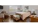 Cozy bedroom with hardwood floors, shuttered windows, and ample natural light at 1243 White Flint Cir, Durham, NC 27703