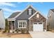 Charming home boasts a harmonious blend of stone and siding, plus an attached garage at 1243 White Flint Cir, Durham, NC 27703