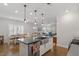Bright open-concept kitchen boasts large island, modern pendant lighting, and stainless steel appliances at 1243 White Flint Cir, Durham, NC 27703