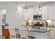 Stylish kitchen island featuring pendant lighting, seating, and stainless steel appliances at 1243 White Flint Cir, Durham, NC 27703