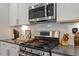 Modern kitchen featuring stainless steel appliances, granite countertops and updated backsplash at 1243 White Flint Cir, Durham, NC 27703