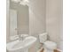 Powder room with white pedestal sink, toilet, and neutral walls at 125 Hidden Springs Dr, Durham, NC 27703