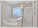 A bright bathroom boasting a large soaking tub and glass enclosed shower at 125 Hidden Springs Dr, Durham, NC 27703