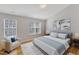 Staged bedroom with vaulted ceiling, hardwood floors, chair and decorative art at 125 Hidden Springs Dr, Durham, NC 27703