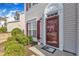Inviting front entrance with storm door, neat landscaping, and decorative accents at 125 Hidden Springs Dr, Durham, NC 27703