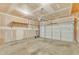 Spacious two-car garage with concrete floor; shelving and a garage door opener at 125 Hidden Springs Dr, Durham, NC 27703