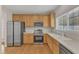 Updated kitchen with stainless steel appliances, light countertops, and wood cabinets at 125 Hidden Springs Dr, Durham, NC 27703