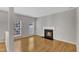 Cozy living room with fireplace, hardwood floors, and large windows at 125 Hidden Springs Dr, Durham, NC 27703
