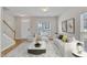 Stylishly furnished living room with hardwood floors and abundant natural light at 125 Hidden Springs Dr, Durham, NC 27703