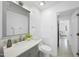 Bathroom with gray vanity, sink, marble countertop, toilet and hallway access at 1277 Teakwood Pl, Raleigh, NC 27606