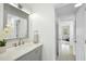 Bathroom with gray vanity, sink, marble countertop and hallway access at 1277 Teakwood Pl, Raleigh, NC 27606