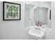 Cozy bathroom with white sink, decorative soaps, and framed wall art at 1277 Teakwood Pl, Raleigh, NC 27606