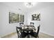 Bright dining room with modern lighting and a large window offering views of the outdoors at 1277 Teakwood Pl, Raleigh, NC 27606