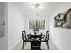 Clean, sun-filled dining room with modern lighting fixture and large window with tree views at 1277 Teakwood Pl, Raleigh, NC 27606