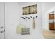 Bright foyer features coat hooks, seating and artwork on the wall, offering a welcoming entrance at 1277 Teakwood Pl, Raleigh, NC 27606