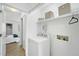 Well-organized laundry area features a modern washer, dryer, and shelving at 1277 Teakwood Pl, Raleigh, NC 27606