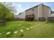 Lush backyard with mature trees, a concrete pad, and stone pavers at 136 Ashlyn Ridge Dr, Garner, NC 27529