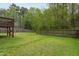 Spacious backyard featuring a well-maintained lawn, a wooden fence, and mature trees at 136 Ashlyn Ridge Dr, Garner, NC 27529
