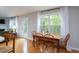 Sunlit dining area with wood floors, a wooden table and views of the outdoor area at 136 Ashlyn Ridge Dr, Garner, NC 27529