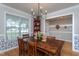 Well-lit dining room with a wooden table, red shelving unit and a view to the backyard at 136 Ashlyn Ridge Dr, Garner, NC 27529