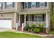Close-up of a home's front porch with white railings, landscaping, and a welcoming entrance at 136 Ashlyn Ridge Dr, Garner, NC 27529
