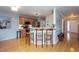 Bright kitchen area with breakfast bar, hardwood floors, wood cabinets and stainless appliances at 136 Ashlyn Ridge Dr, Garner, NC 27529