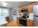 Modern kitchen features stainless steel appliances, a white countertop and hardwood floors at 136 Ashlyn Ridge Dr, Garner, NC 27529