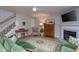 Cozy living room featuring hardwood floors, a fireplace, and comfortable armchairs and sofas at 136 Ashlyn Ridge Dr, Garner, NC 27529