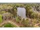Breathtaking aerial view of a serene lake surrounded by lush greenery and beautiful homes at 144 Arabella Ct, Cary, NC 27518
