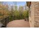 Spacious back deck with metal railing overlooks lush greenery, offering a serene outdoor retreat at 144 Arabella Ct, Cary, NC 27518
