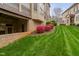 Beautifully landscaped backyard with vibrant pink flowers, and a well-maintained lawn at 144 Arabella Ct, Cary, NC 27518