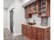 Cherry cabinets, stone counters, and a modern sink make this bar area a delight at 144 Arabella Ct, Cary, NC 27518