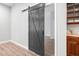 Stylish black barn door adds character to the living space at 144 Arabella Ct, Cary, NC 27518