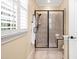 Elegant bathroom featuring a glass enclosed tiled shower, a neutral color palette and bright natural light at 144 Arabella Ct, Cary, NC 27518