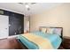 Bedroom featuring hardwood floors, a ceiling fan and an accent wall at 144 Arabella Ct, Cary, NC 27518