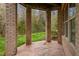 Covered patio with brick columns offers a shaded retreat with a view of the lush backyard at 144 Arabella Ct, Cary, NC 27518
