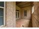 Covered patio with brick columns offers a shaded retreat with a view of the backyard at 144 Arabella Ct, Cary, NC 27518