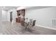 Modern glass dining table complements the wet bar in this stylish basement at 144 Arabella Ct, Cary, NC 27518