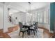 Bright dining room boasts stylish chandelier, shutters, and seating for six at 144 Arabella Ct, Cary, NC 27518
