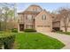 Charming home with a well-manicured lawn, brick and stone facade, and a two-car garage at 144 Arabella Ct, Cary, NC 27518
