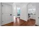 Inviting foyer with hardwood flooring offering seamless transition between kitchen and dining area at 144 Arabella Ct, Cary, NC 27518